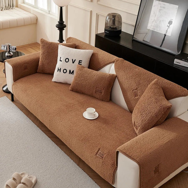 Non-slip plush sofa cover, secures furniture. Stylish & practical couch protector, ideal for pet-friendly homes.