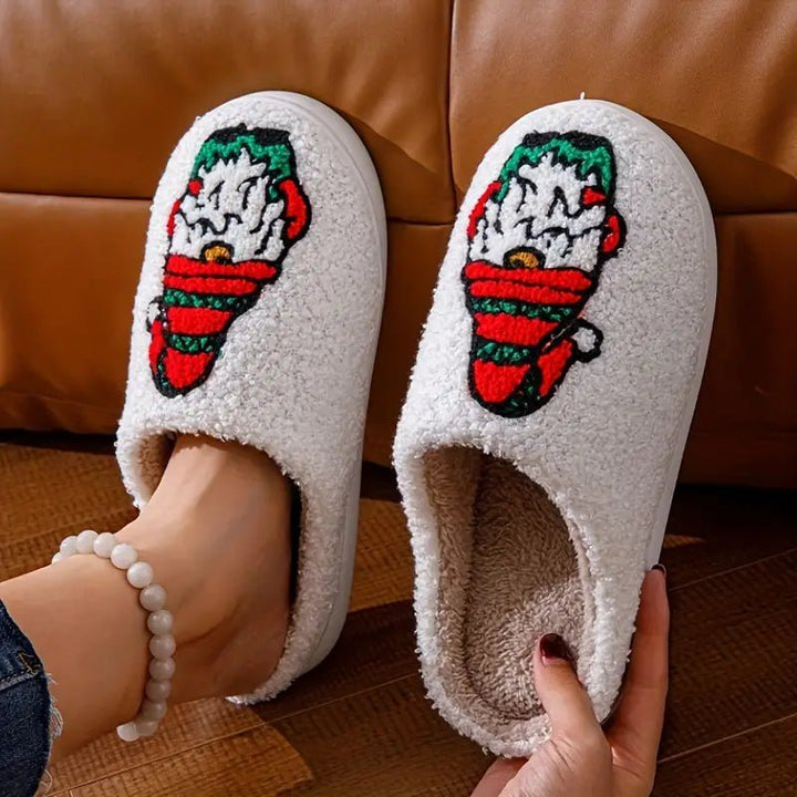 Unisex plush winter house slippers. Festive deer pattern, warm lining, & non-slip grip sole for comfort.