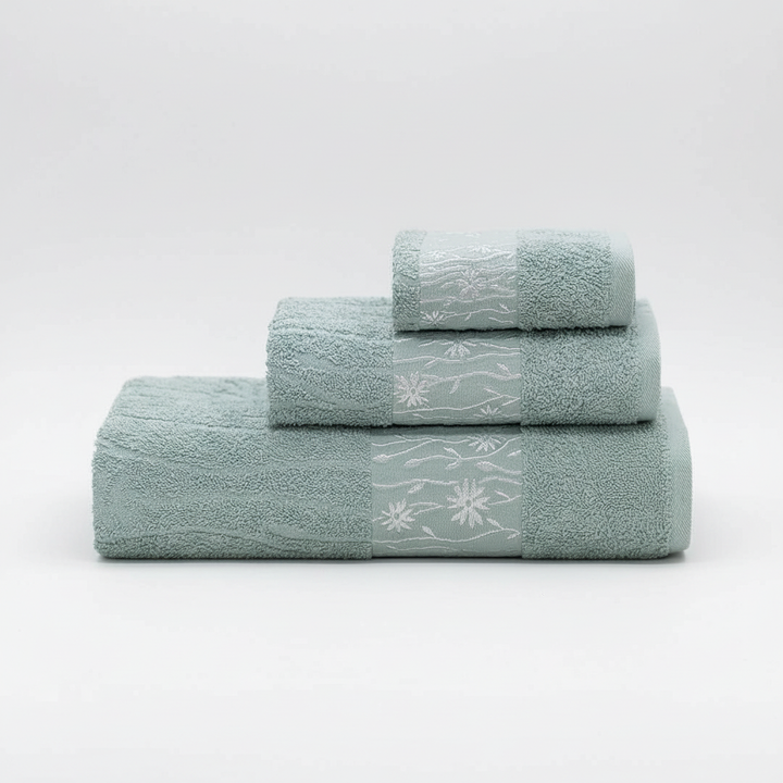 Elegant stack of a 3-piece white cotton towel set, featuring premium bath linen and home essentials