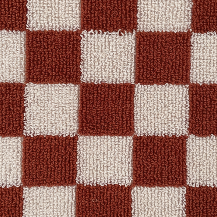 Stacked premium cotton bath towels in a spa setting, emphasizing their softness and easy care properties.