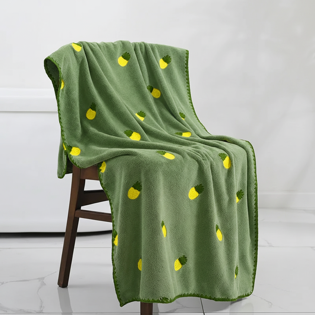 Textured quick-dry bath towel with detailed fruit embroidery, designed for maximum absorbency.
