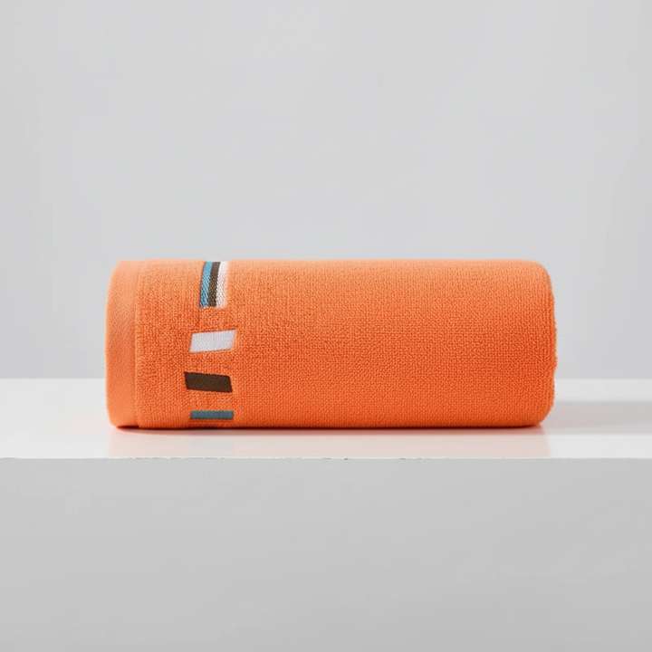 Unisex luxury cotton towel set in a folded display, highlighting its softness and high absorbency.