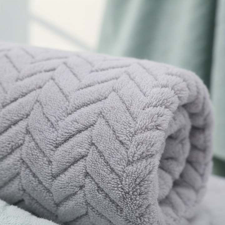 Close-up of a soft blue microfiber bath towel, highlighting its texture and quick-dry properties.
