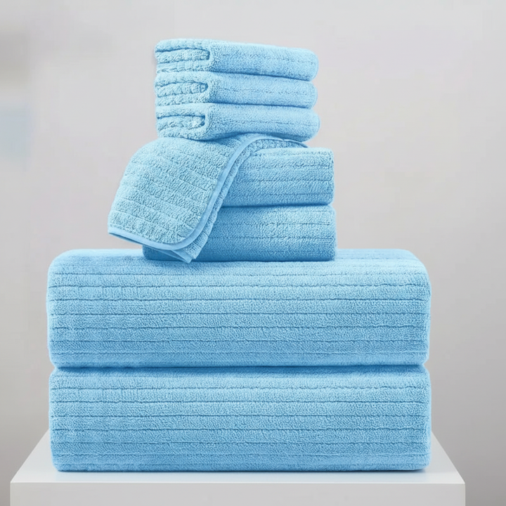 Rolled quick-dry terry bath towels in a set, showcasing their soft, absorbent quality for bath linen.