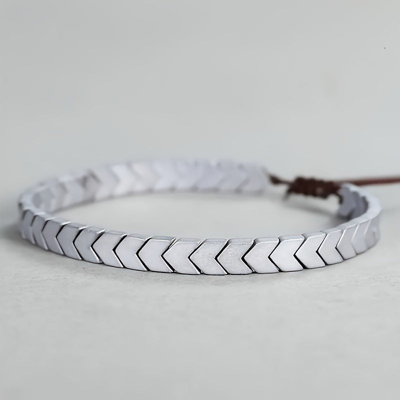 Sleek minimalist polished hematite beaded bracelet. Natural stone fashion accessory, versatile unisex design.