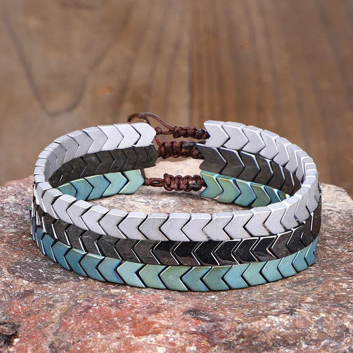 Close-up: Polished hematite beaded bracelet, smooth natural stone beads. Durable unisex spiritual jewelry.