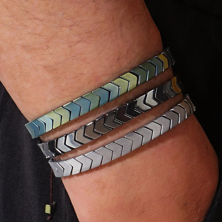 Unisex polished hematite beaded bracelet on wrist. Adjustable fit, stylish natural stone fashion accessory.