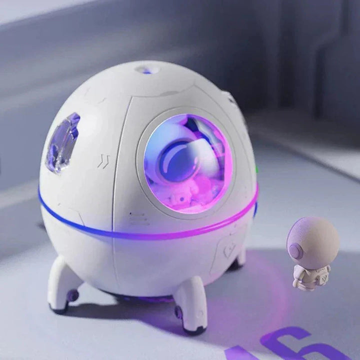 Compact USB rechargeable astronaut humidifier & aroma diffuser with LED night light. Pink/white space theme decor.