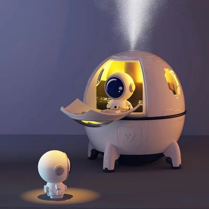 Pink portable astronaut humidifier & aroma diffuser with LED night light. USB rechargeable, soothing home decor.