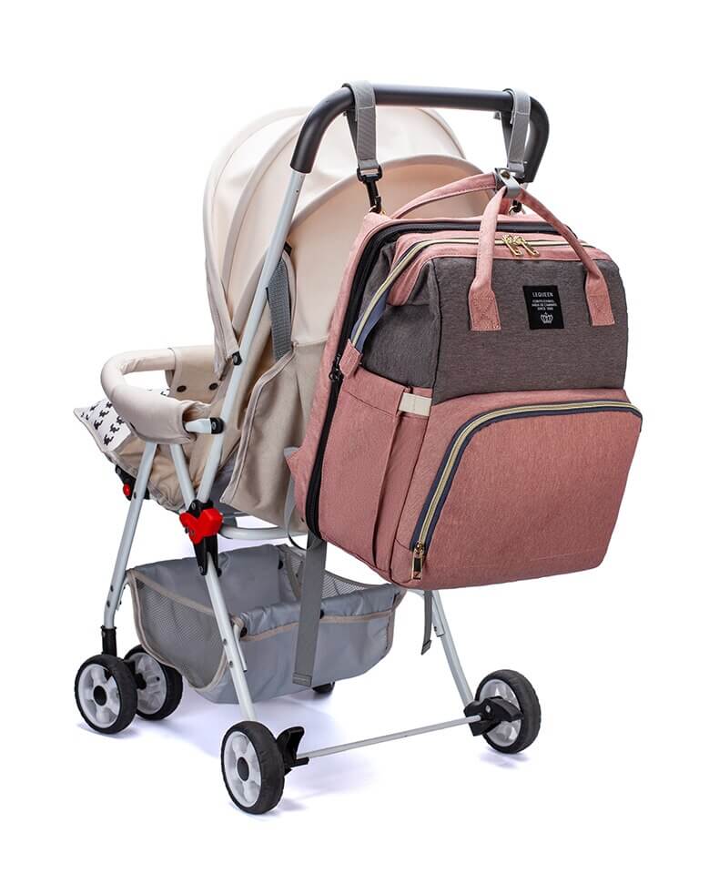 Fully expanded multi-function baby bag showcasing the portable bed and mesh storage pockets.