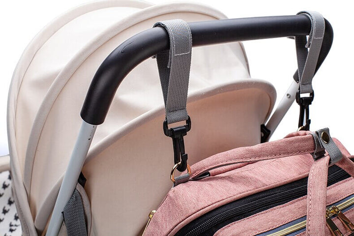 Stylish grey baby travel backpack, packed with baby essentials, suitable for a changing station.
