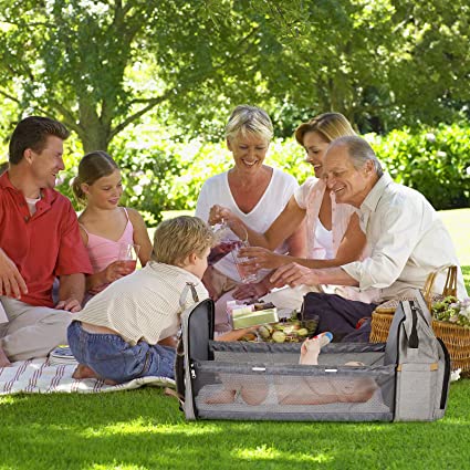 A mother easily setting up the portable changing bed from her multi-function baby travel backpack.