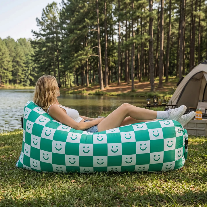 Portable blue inflatable air sofa, ideal outdoor lounger for easy setup camping, beach, or garden relaxation.