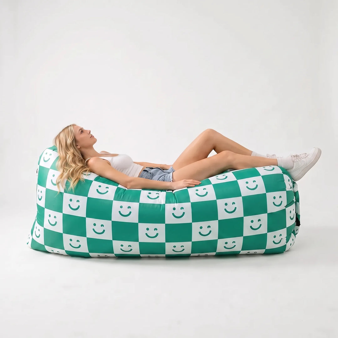 Green inflatable outdoor sofa, no pump needed. Perfect portable seating for patio, garden, beach & festival comfort.