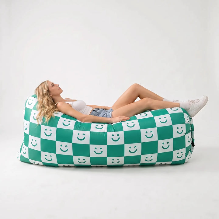 Green inflatable outdoor sofa, no pump needed. Perfect portable seating for patio, garden, beach & festival comfort.
