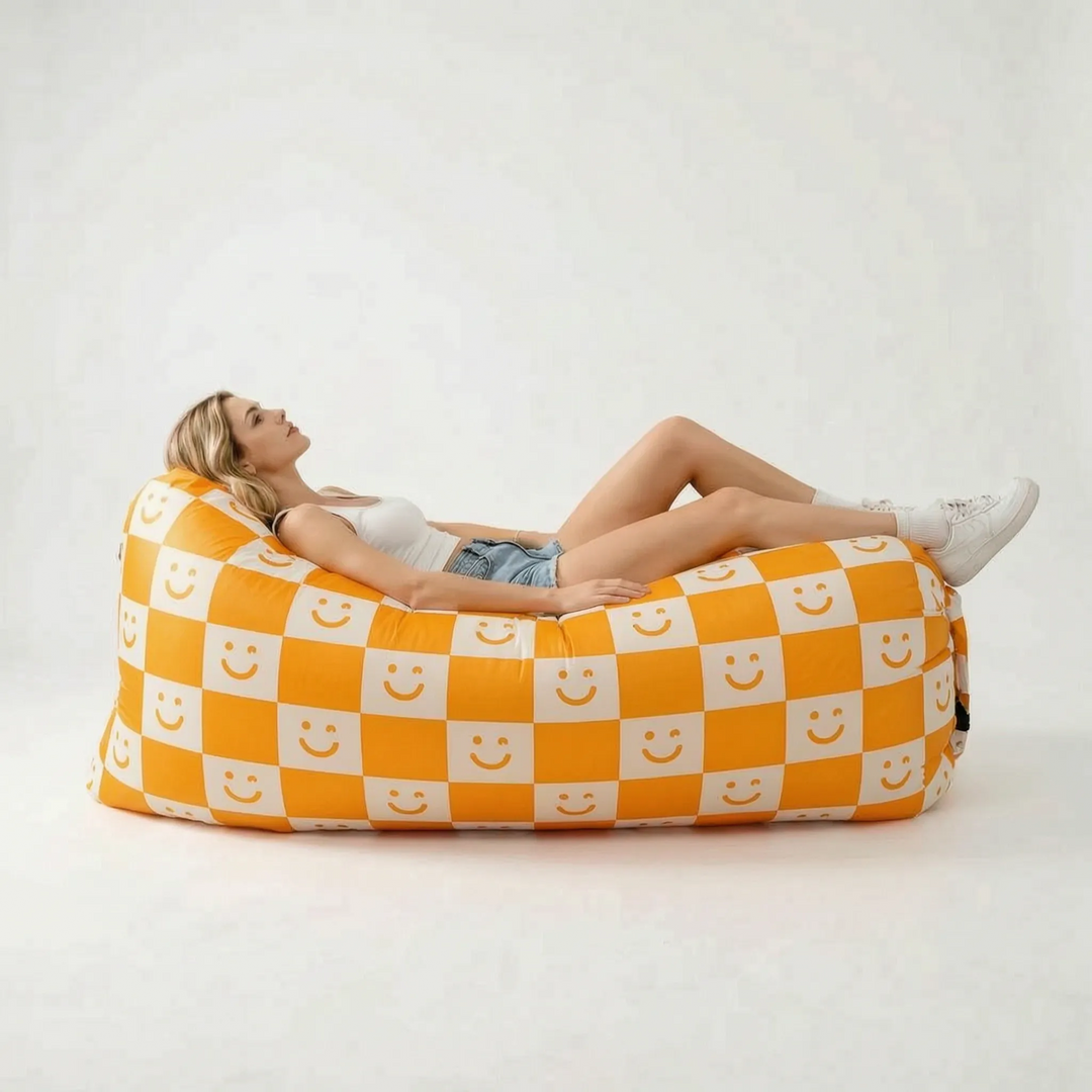 Durable red inflatable air sofa, a convenient portable outdoor couch for camping, patio, and festival seating.