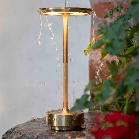 Black portable desk lamp, LED & cordless with adjustable brightness. Modern metal design for home lighting.
