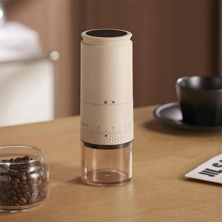 Grinding coffee beans with a quiet, portable electric grinder, ensuring a perfect fresh brew every time.