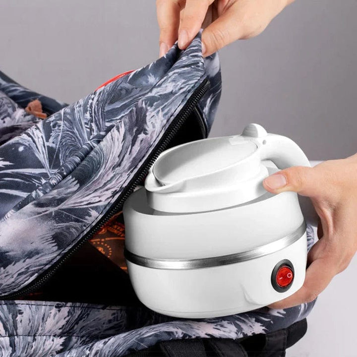 Collapsible electric kettle for camping kitchen setups, quickly boils water for coffee or tea.