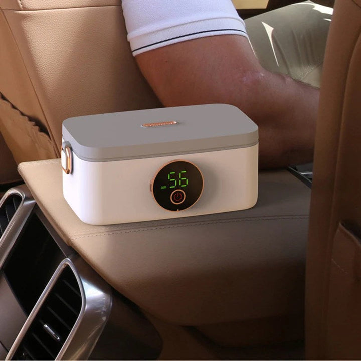 Portable electric heated lunch box with stainless steel interior for warm meals on the go.