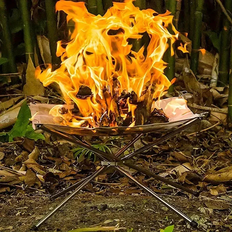 Foldable stainless steel campfire grill stand for outdoor cooking, camping & picnics. Easy portable setup.