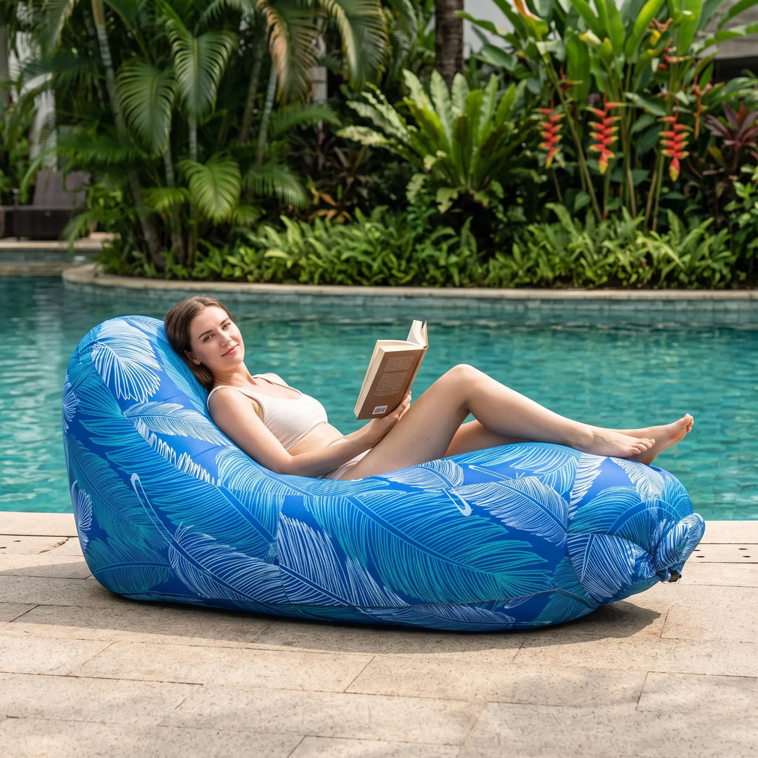 Portable inflatable outdoor lounge chair for beach, camping, or park relaxation. Easy setup travel gear.