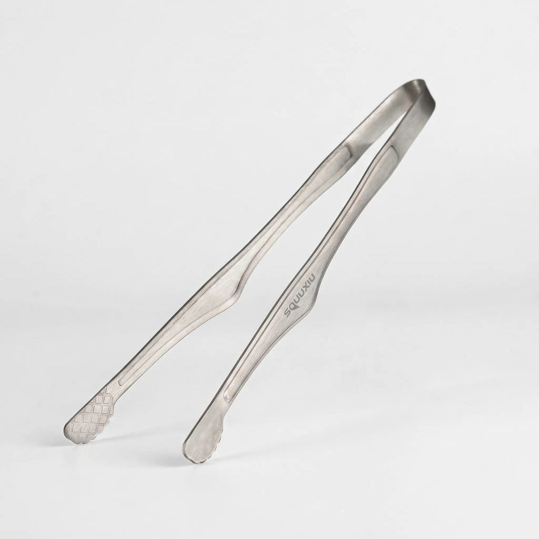 Durable camping grill plate & tongs for solo hiking, backpacking, and outdoor cooking adventures.