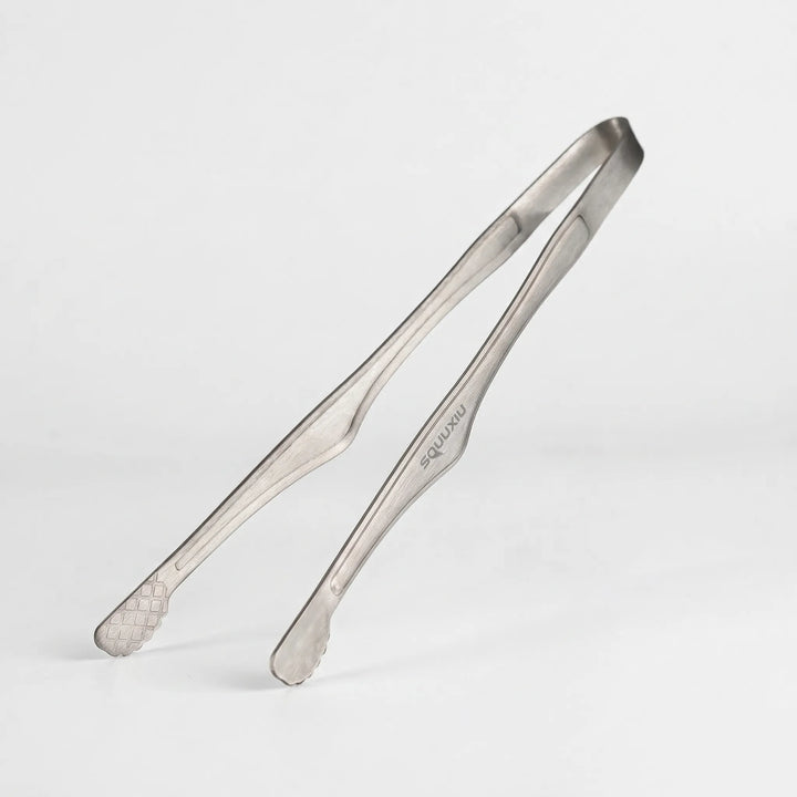 Durable camping grill plate & tongs for solo hiking, backpacking, and outdoor cooking adventures.