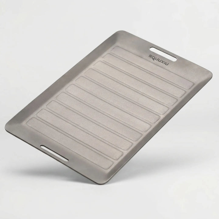 Versatile portable grill plate with tongs, perfect for solo meals and easy outdoor camp kitchen setup.