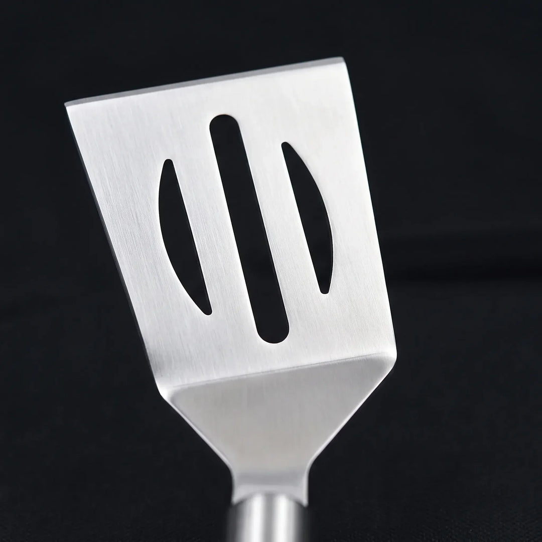 Durable stainless steel BBQ tool set, perfect for outdoor grilling, includes spatula, tongs, fork.