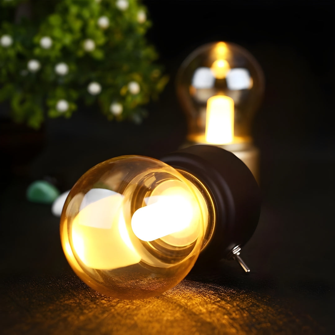Retro portable LED table lamp with a dark base and elegant lampshade, USB rechargeable for versatile use.