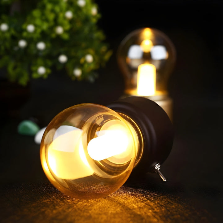 Retro portable LED table lamp with a dark base and elegant lampshade, USB rechargeable for versatile use.