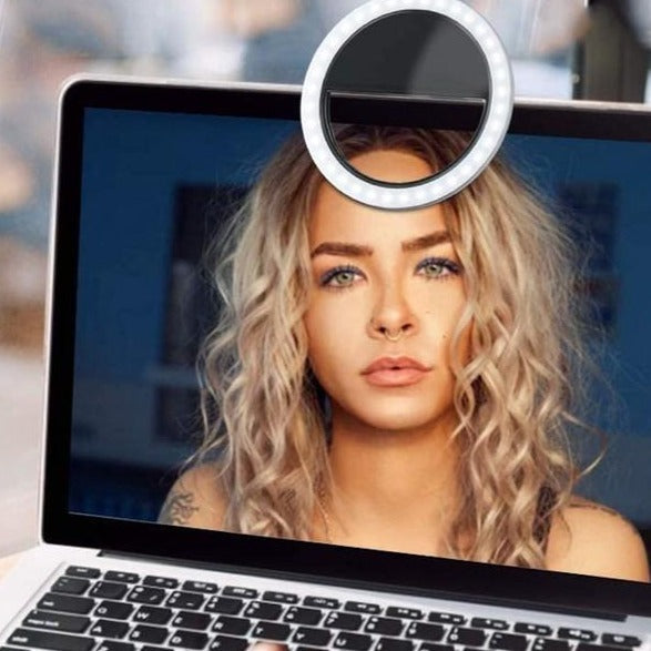 Clip-on ring light illuminating a user for professional-looking video conferences & online meetings.