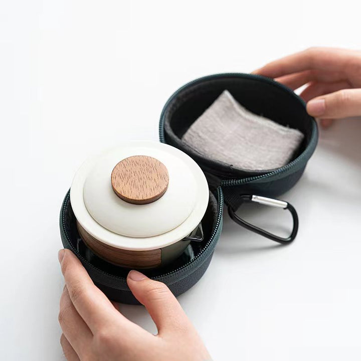 Compact tea set for travel, featuring a small teapot, 3 durable cups, and a tea infuser for your favorite brew.