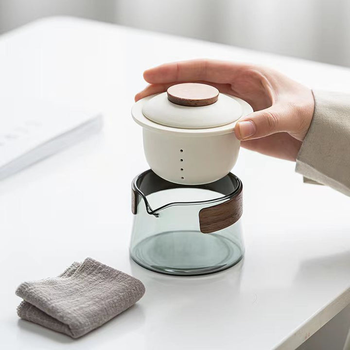 On-the-go loose leaf tea set, including a portable teapot and three ceramic cups, ideal for office or travel.