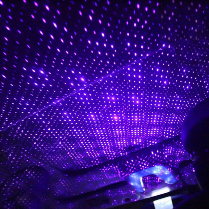 Compact StarGlow USB star projector casting a galaxy light display, perfect as a portable mood light or night light.