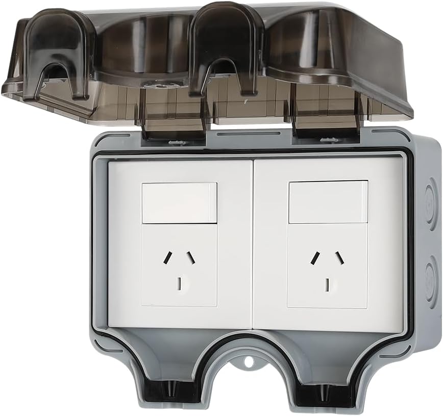 Installed PowerGuard IP66 waterproof electrical outlet with lockable cover on an exterior wall, gray finish