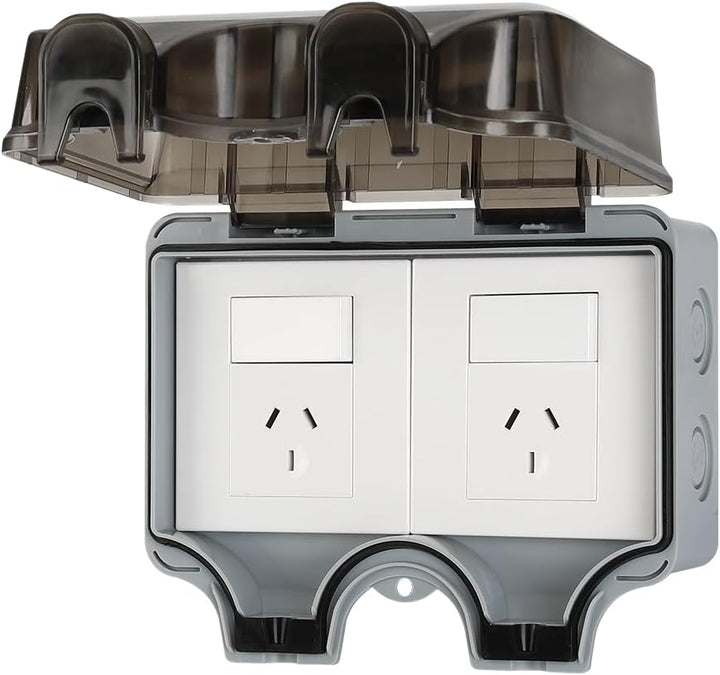 Installed PowerGuard IP66 waterproof electrical outlet with lockable cover on an exterior wall, gray finish