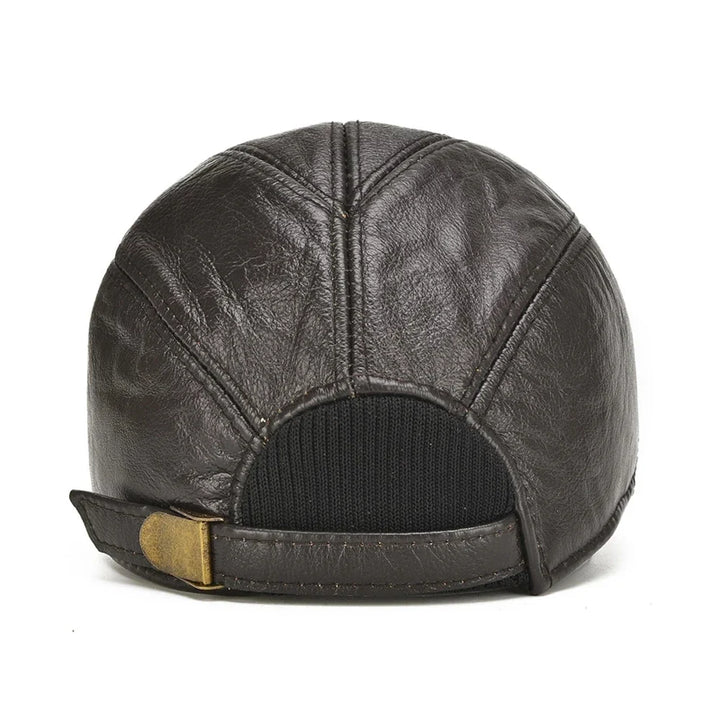 Close-up of a premium black leather cap, showing cowhide texture and durable craftsmanship. Adjustable unisex fit.