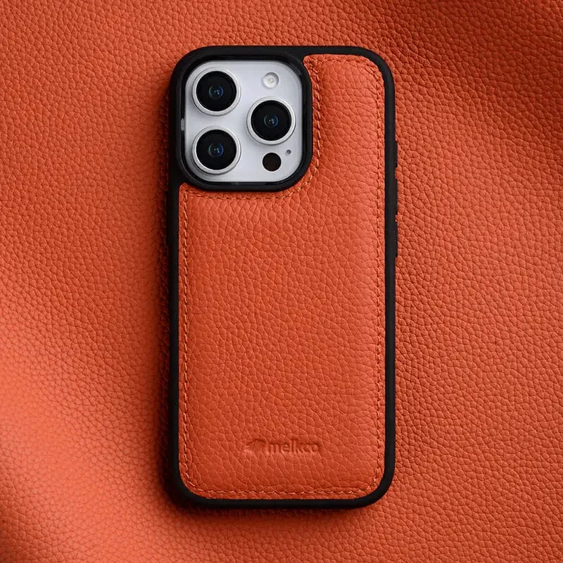 Hand holding a colorful Italian leather iPhone 15 case, showcasing its sleek design & luxury.