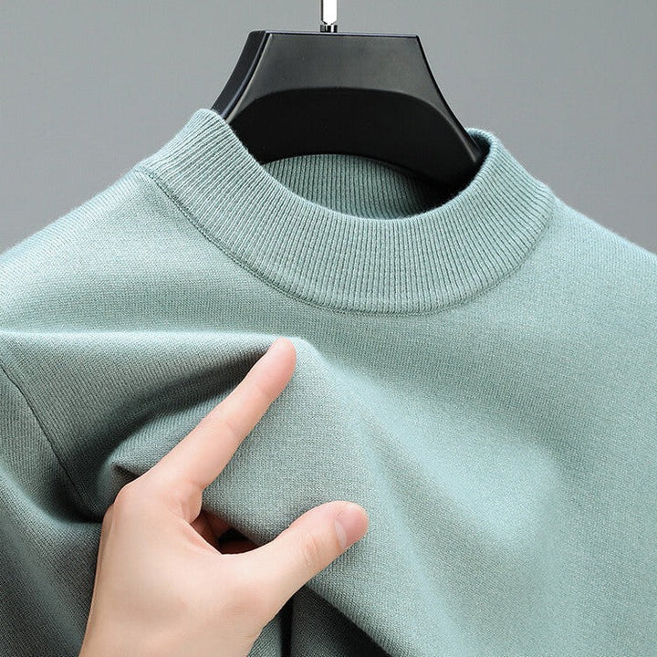 Sophisticated long sleeve men's cashmere sweater with elegant hem, ideal for versatile styling.