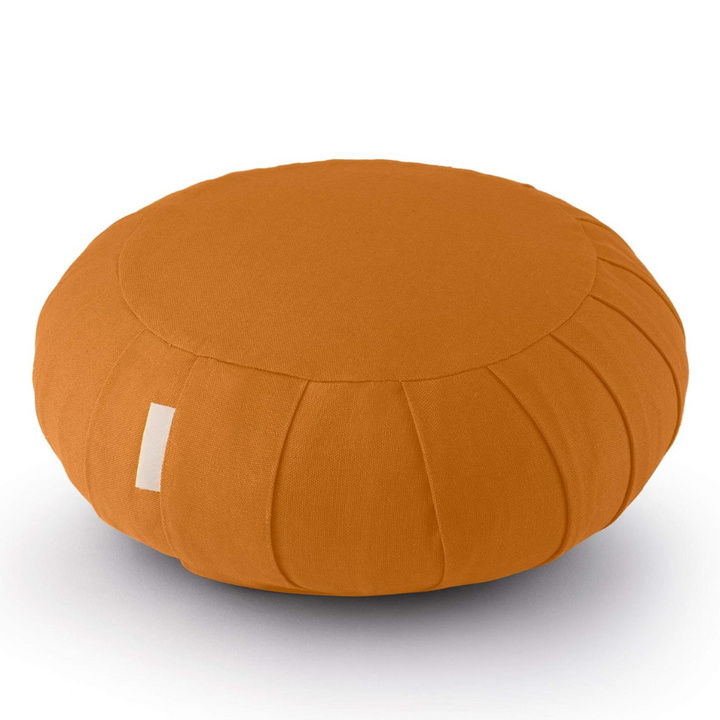 Meditation cushion in a serene setting, made with organic cotton and buckwheat for peaceful practice.
