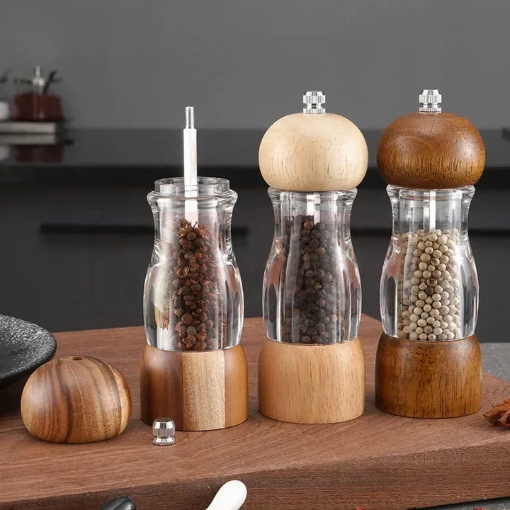 Manual wood salt & pepper grinder set on a kitchen table, perfect for seasoning daily meals.