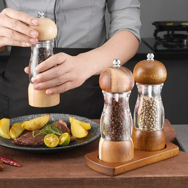 Top view of sleek manual wood salt and pepper mills, showing ergonomic design & grinding mechanism.