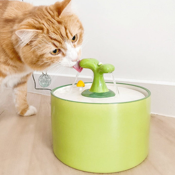 Green ceramic cat drinking fountain, quiet automatic water dispenser for pet hydration.