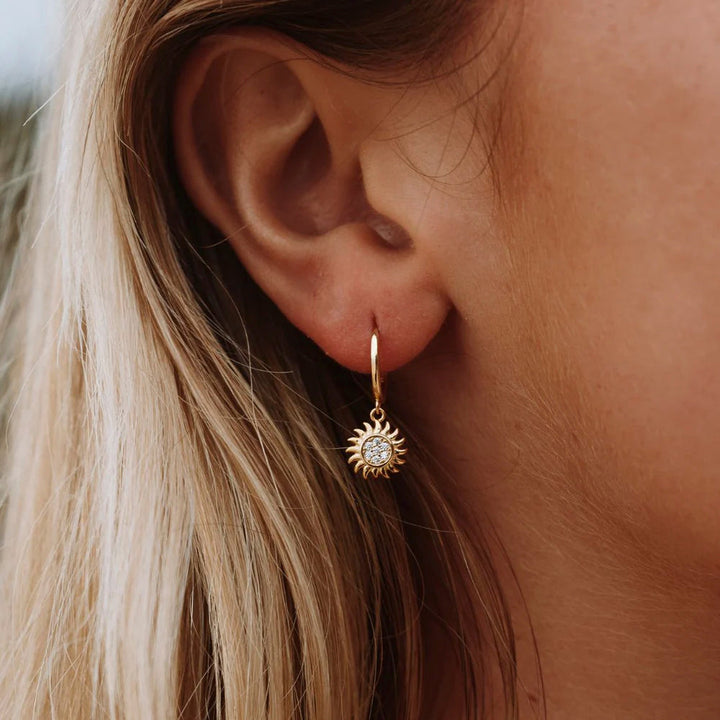 Radiant gold & silver sun drop earrings for women. Elegant celestial jewelry, perfect fashion accessory.