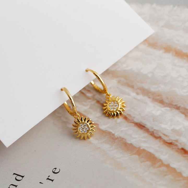 Chic gold & silver sun drop earrings. Women's elegant celestial jewelry, perfect for any occasion.
