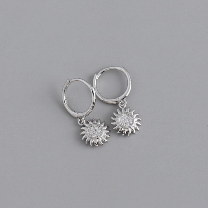 Stunning women's sun drop earrings crafted from gold and silver. Elegant celestial jewelry accessory.