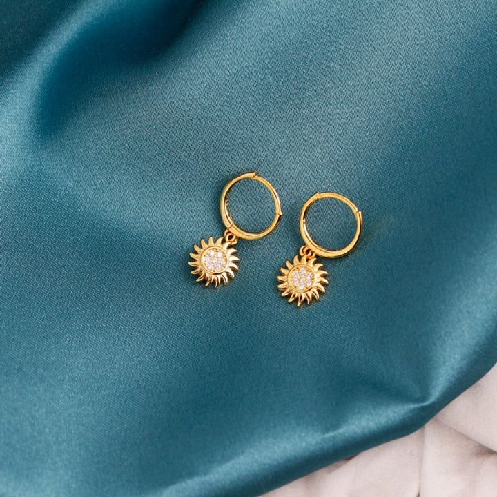 Fashionable women's gold & silver sun drop earrings. Versatile celestial jewelry, a radiant style statement.