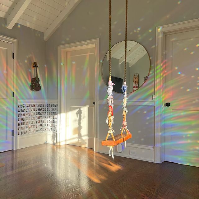 Reusable sun catcher window decal, scattering rainbows in a room, offering bird safety and aesthetic appeal.